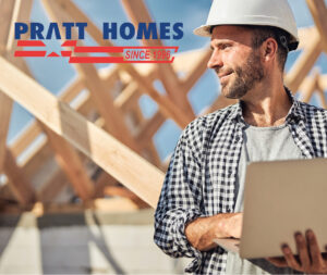 project manager on a construction site with a helmet and a laptop Pratt Homes, Tyler, Texas